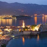 Budva old medieval walled city lights at night. Center of Montenegrin tourism, medieval walled city at Adriatic sea coastline. Montenegro. Europe.