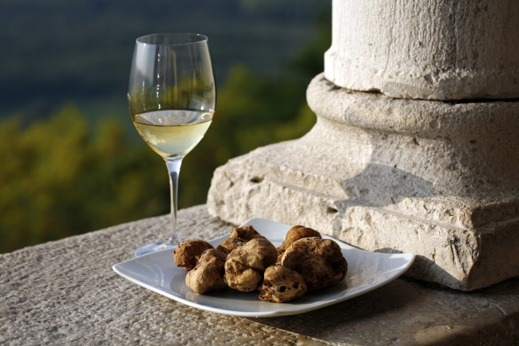 Croatia souvenirs - a plate of Croatian truffles with a glass of white wine