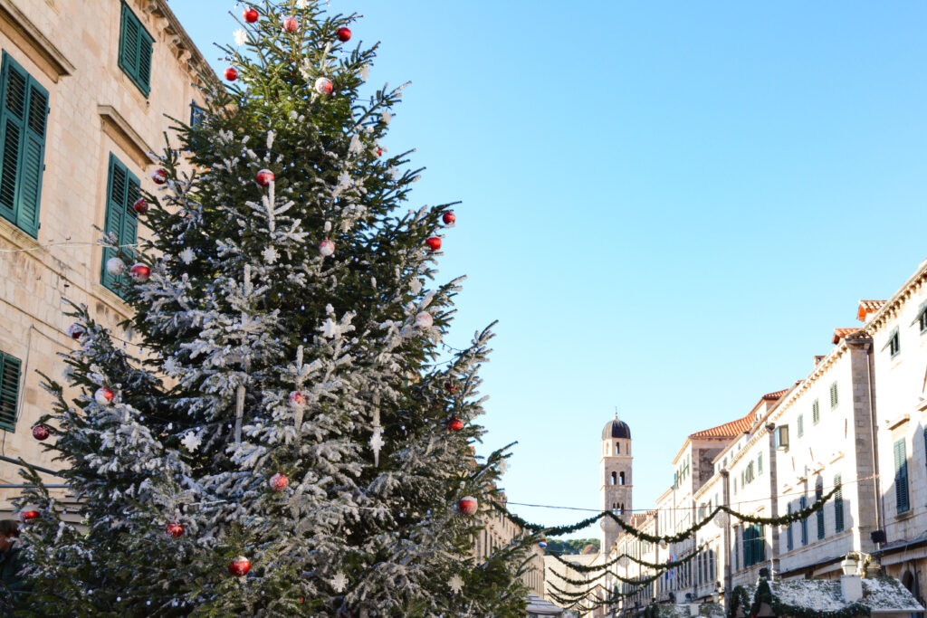 Dubrovnik Christmas Market with a snow cover tree and decorations lining the steet