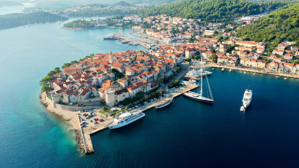 Korčula, an island with history buildings and a bustling harbor seen from above
