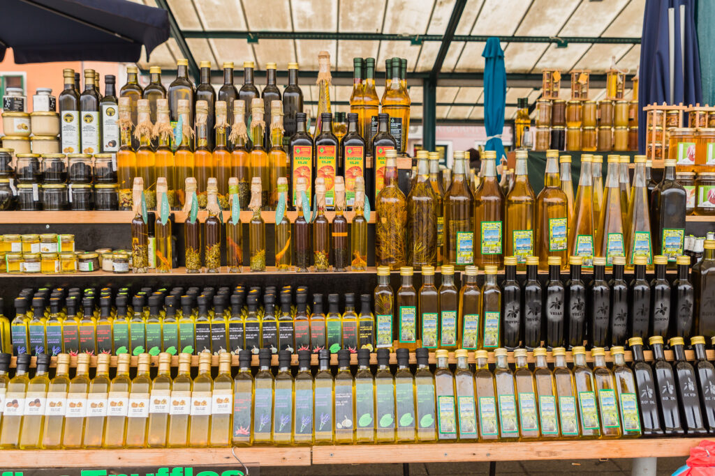 Olive oil bottles being sold on a wooden stall in Croatia
