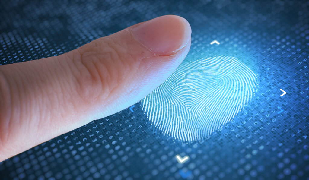 a finger being placed down on a blue finger print reader 