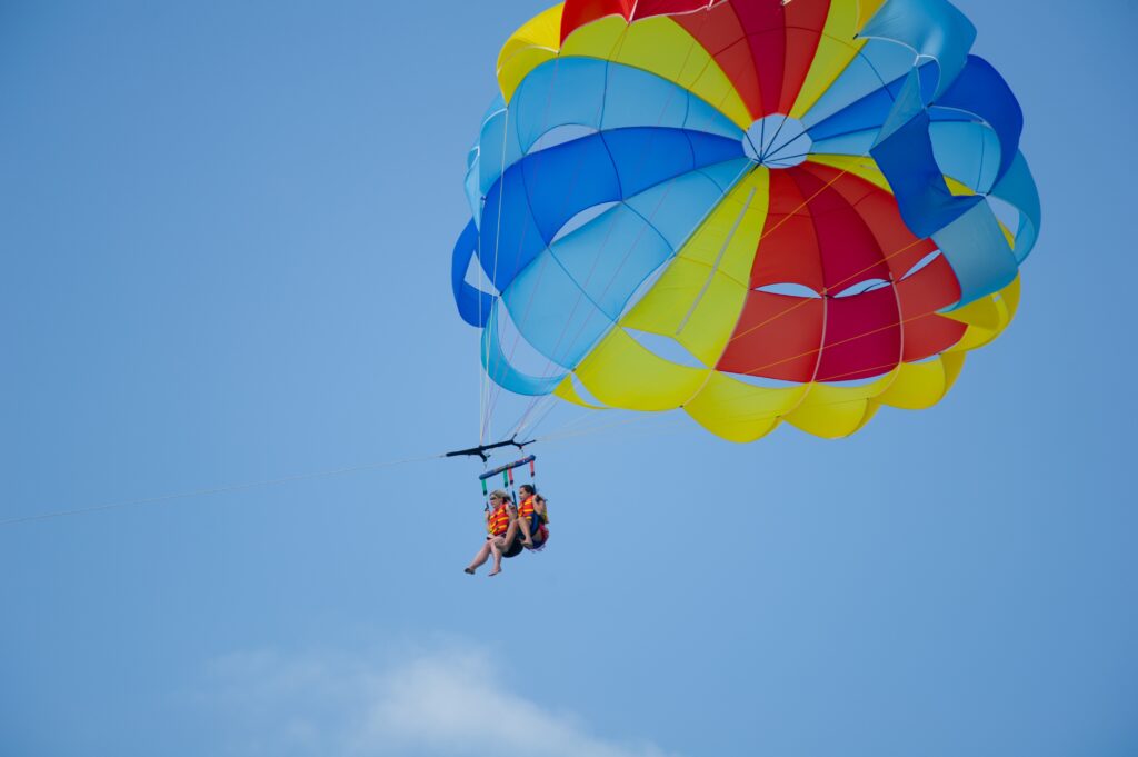 a couple floating in the sky with a parachute above them (a Croatian invention)