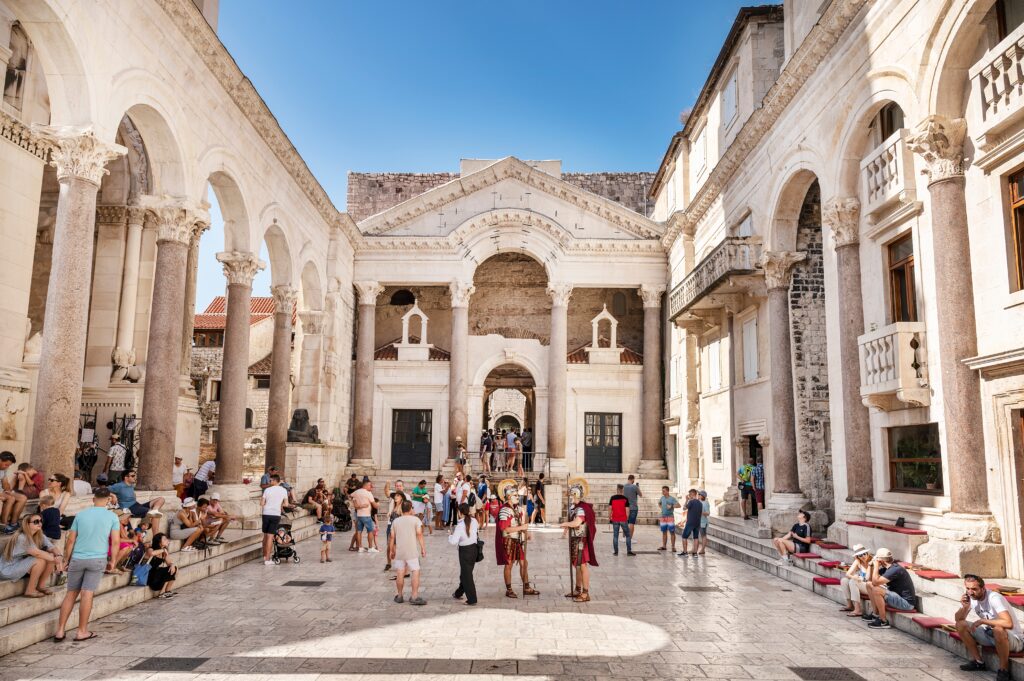 how safe is Croatia for travel - people talking and dressed up in roman gladiator outfits outside the Diocletian's Palace