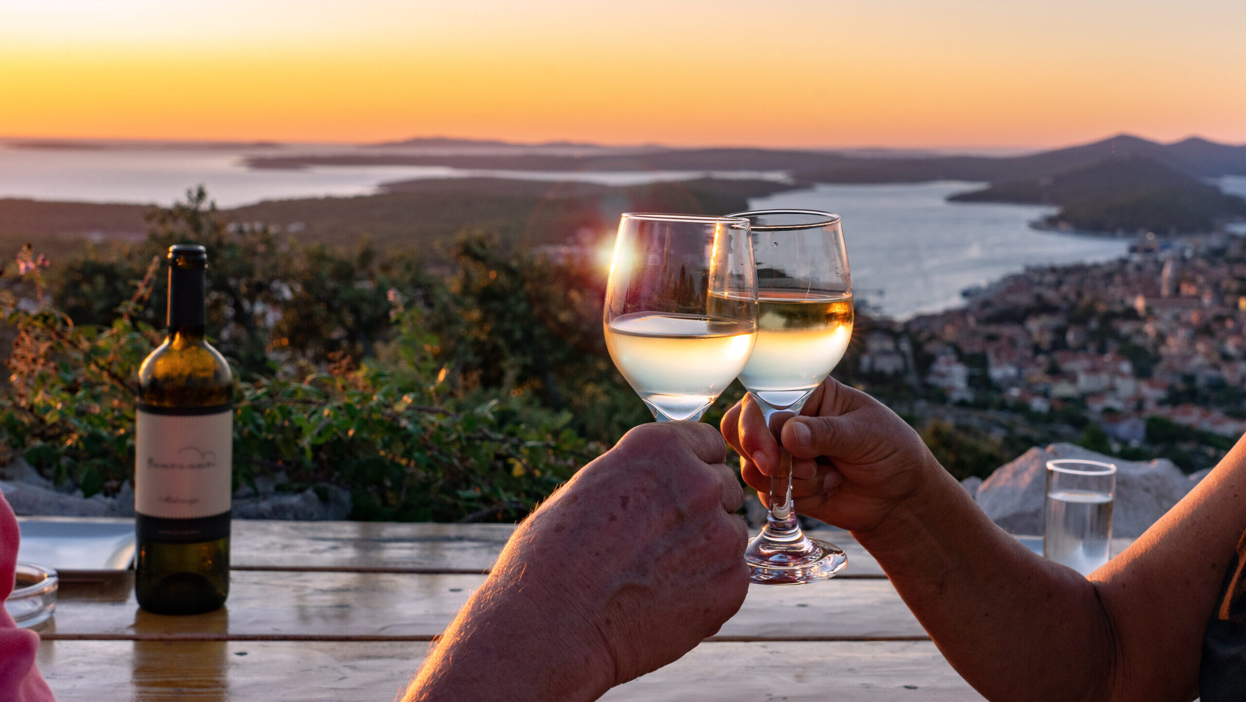 couple clinking glasses of Croatian wine in the wine regions of Croatia